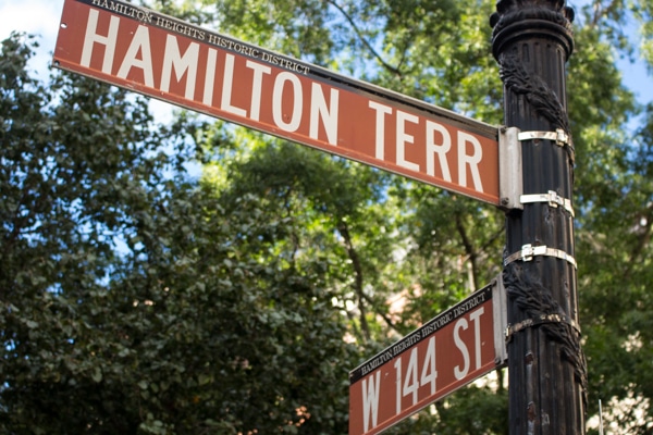 Street sign indicating the corner of Hamilton Terrace and W. 144 St. 