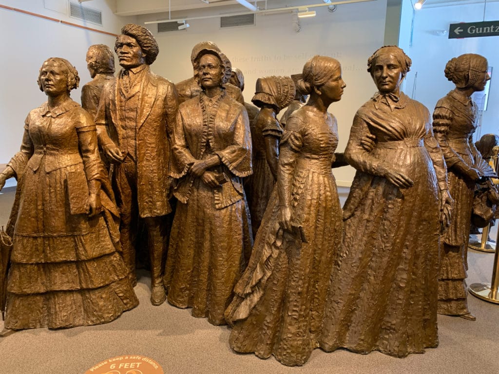 Bronze statue depicting about ten people who were attendees at the Seneca Falls Convention.