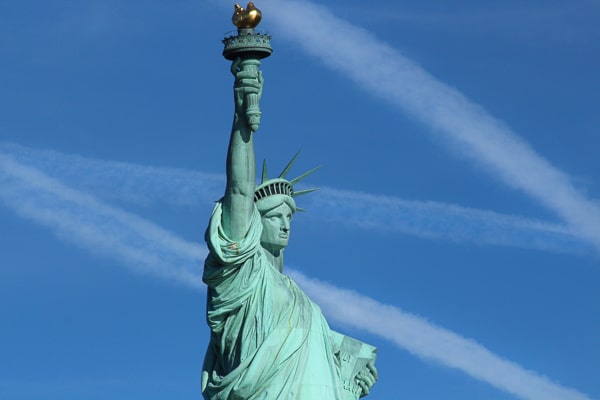 Close-up of the Statue of Liberty from the waist up to almost the top of the torch. 