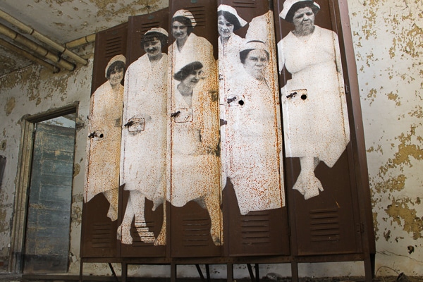 A life-sized black-and-white photo of 7 nurses plastered across a row of lockers. 