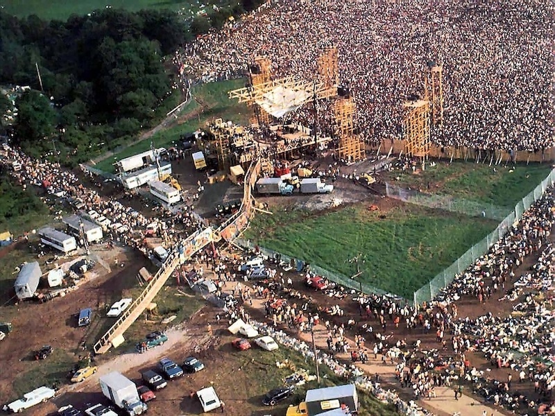 Aerial shot of stage and large crowd at Woodstock 1969.