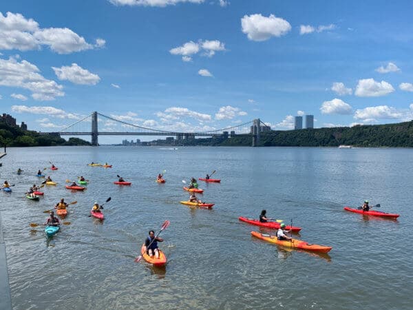Kayaks on the Hudson River. View of George Washington Bridge in the background.