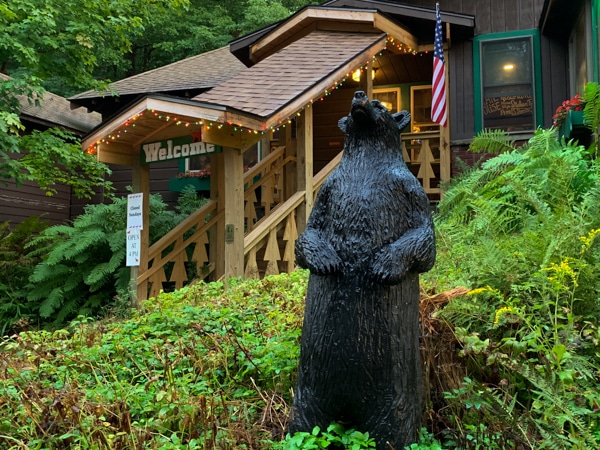 Exterior of Red Dog Cafe. A carved wooden bear is near the entrance.