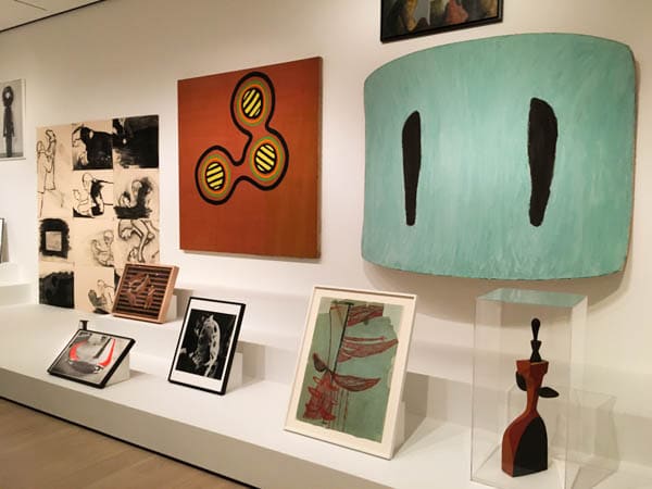 A selection of 7-8 artworks, arranged on low shelves at the Museum of Modern Art.
