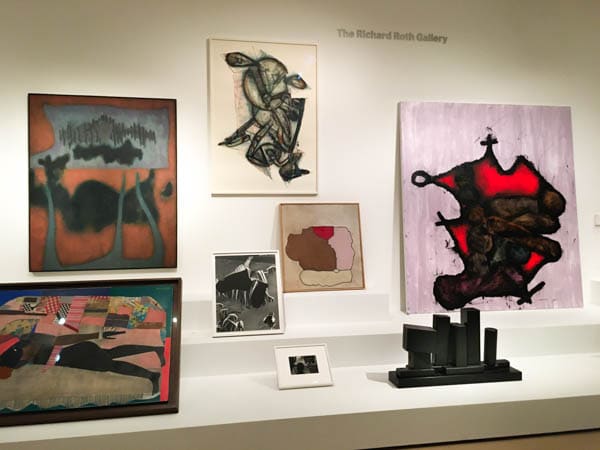 A selection of 7-8 artworks, arranged on low shelves at the Museum of Modern Art.