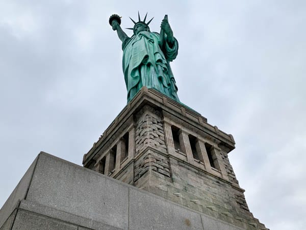 A view of the Statue of Liberty from beneath it, looking up.