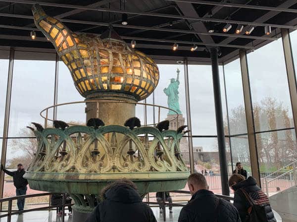 The old Statue of Liberty torch, now inside the new museum on Liberty Island. The actual Statue of  Liberty can be seen in the distance. 