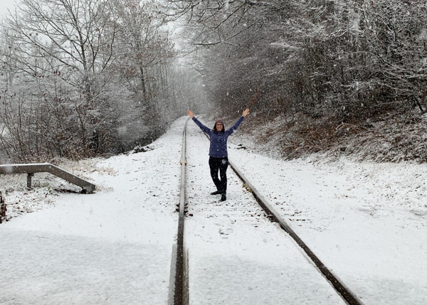 Author standing on railroad tracks on a snowy day.