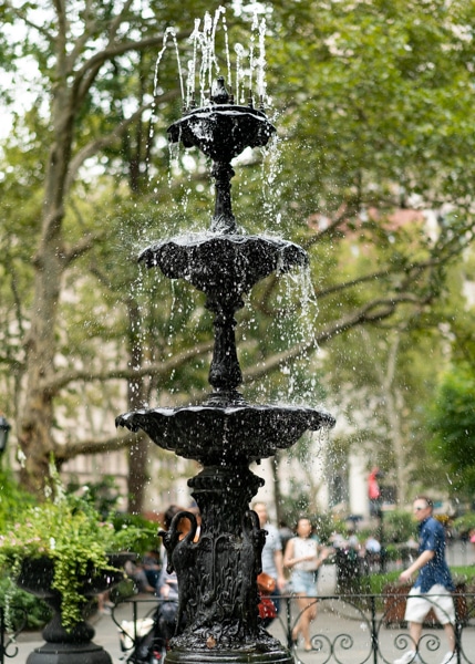 Three-tiered fountain with water running at Madison Square Park.