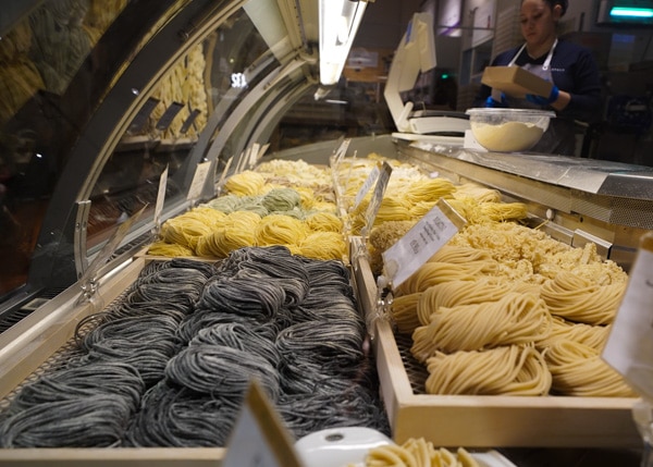 Several rows of homemade spaghetti sitting inside a cooler at Eataly.