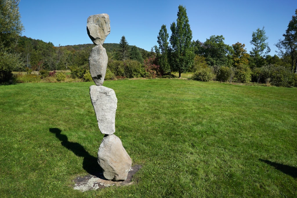 A stack of four small boulders balancing on top of each other. 