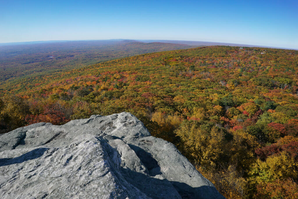 A long distance view of fall foliage viewed from a flat rocky ledge, at Sam's Point near Ellenville, NY. 