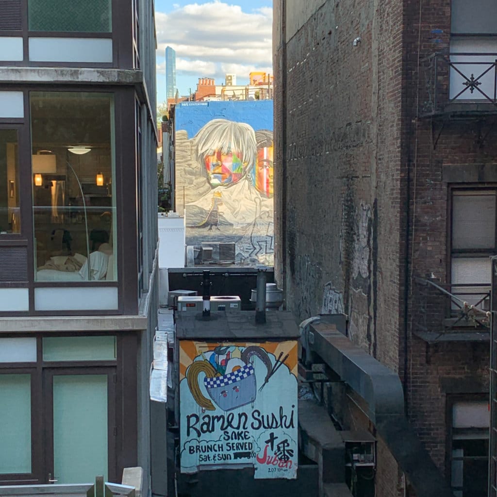 Partial view of a mural featuring Andy Warhol and Frida Kahlo.