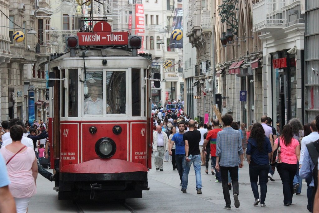 Red trolley car coming down the street in Istanbul.