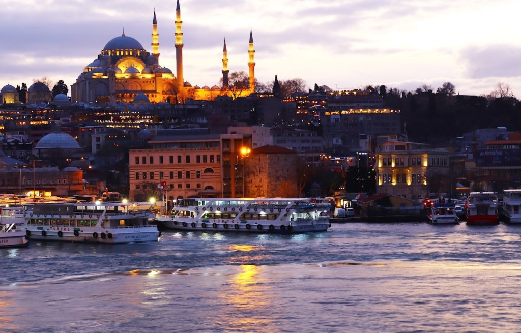 View of a mosque and ferry boats from the Bosphorus in Istanbul.