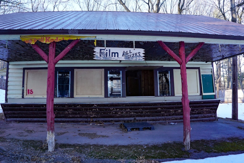 Dilapidated concession stand with a sign indicating they used to sell Kodak film.