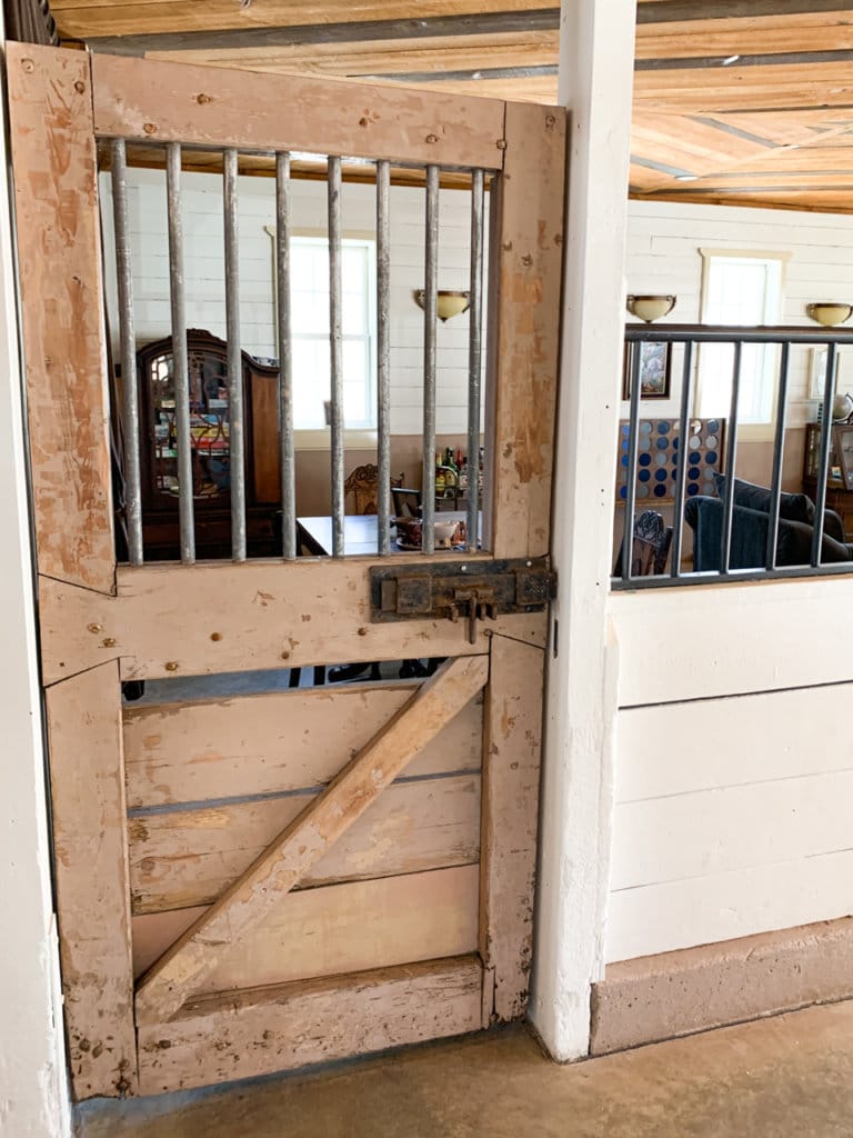 Wood door with metal bars on the top portion. Former door for giraffe pen.