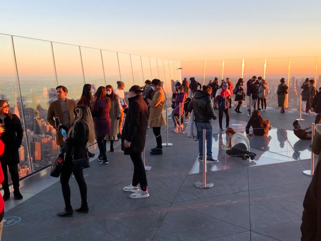 A crowd of people on the sky deck at Edge at sunset.