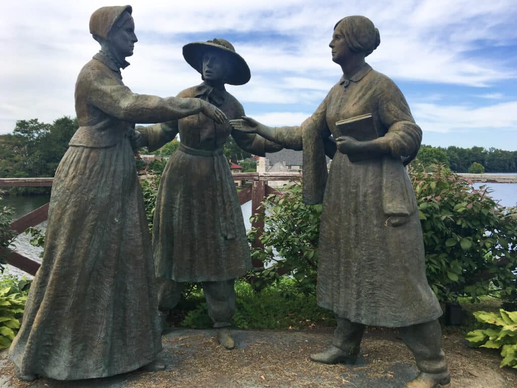 A bronze statue depicting three women: Susan B. Anthony, Amelia Bloomer, and Elizabeth Cady Stanton.