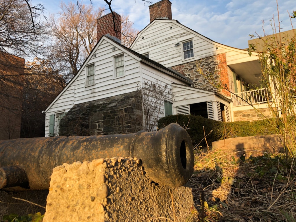Close-up view of a cannon sitting outside of the Dyckman Farmhouse Museum. 