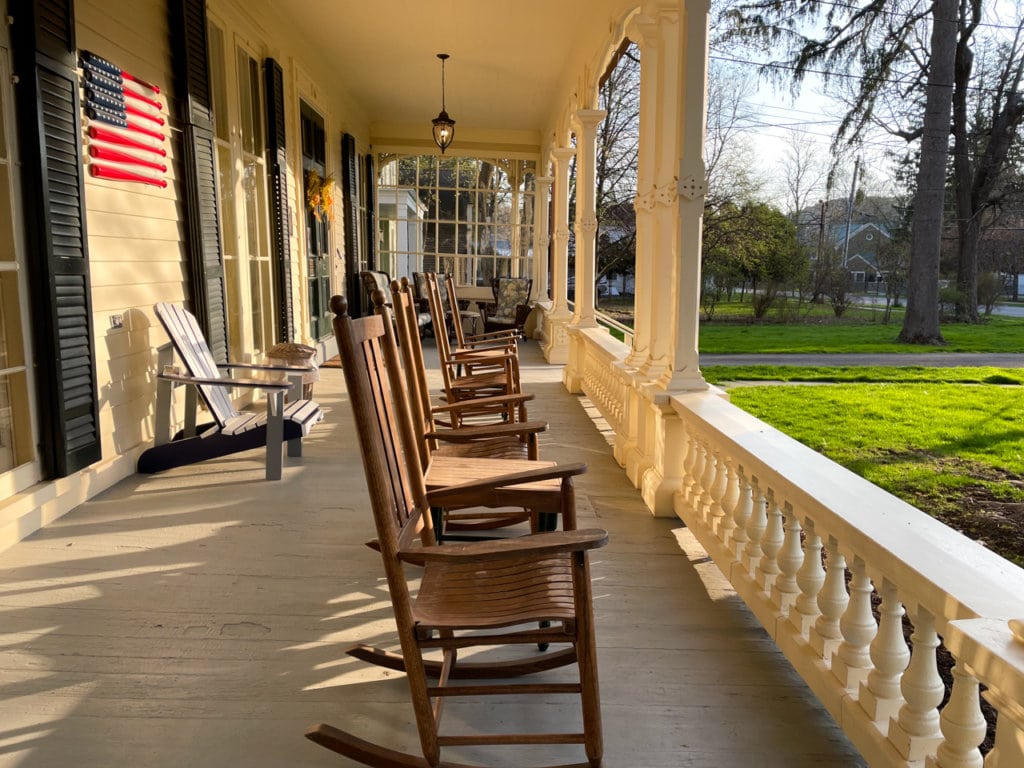 A row of rocking chairs on the porch at the Inn at Cooperstown in Cooperstown, NY.