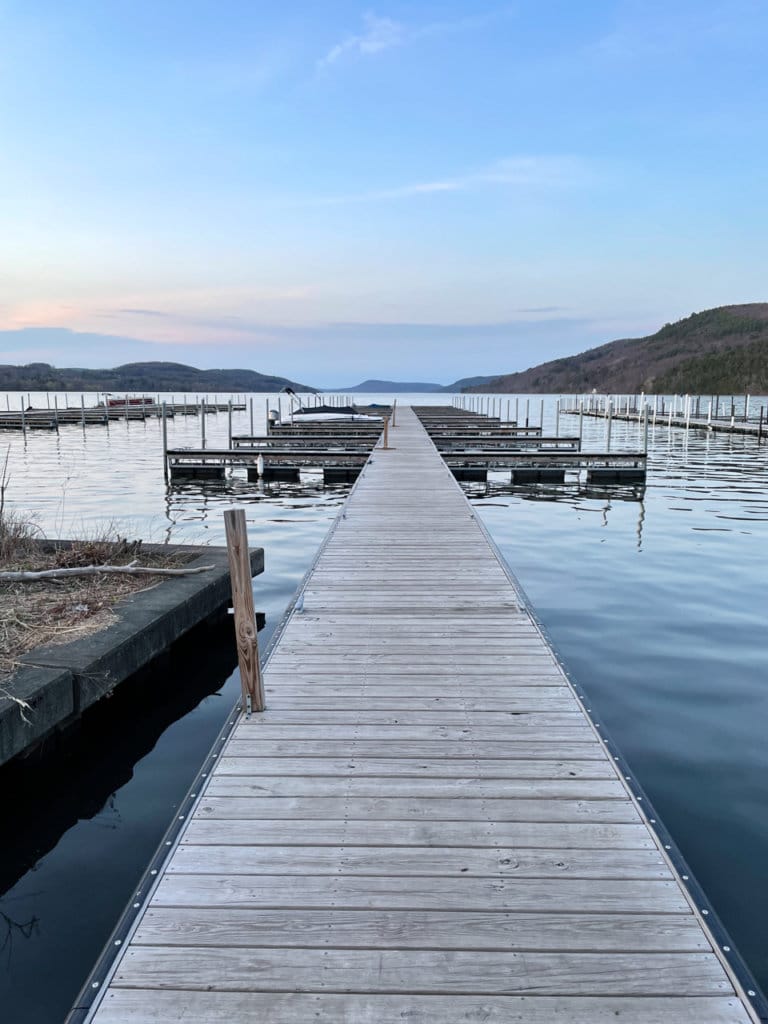 A long dock in Lake Otsego at sunset in Cooperstown, NY.