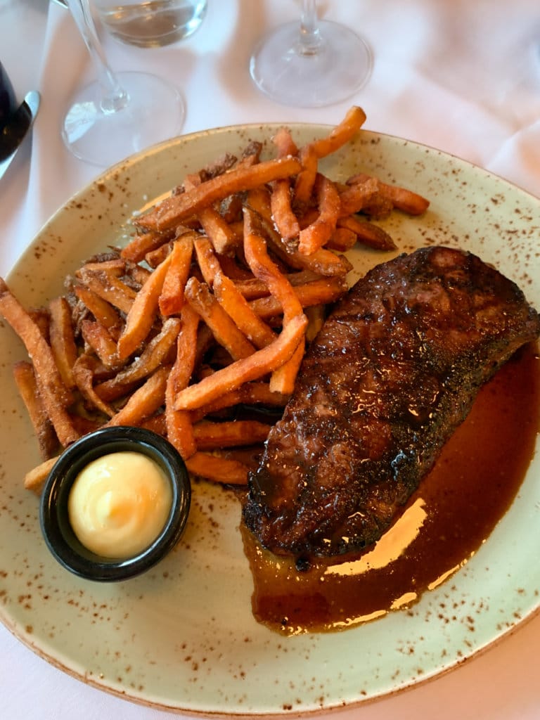 Steak and French fries served in a restaurant. 