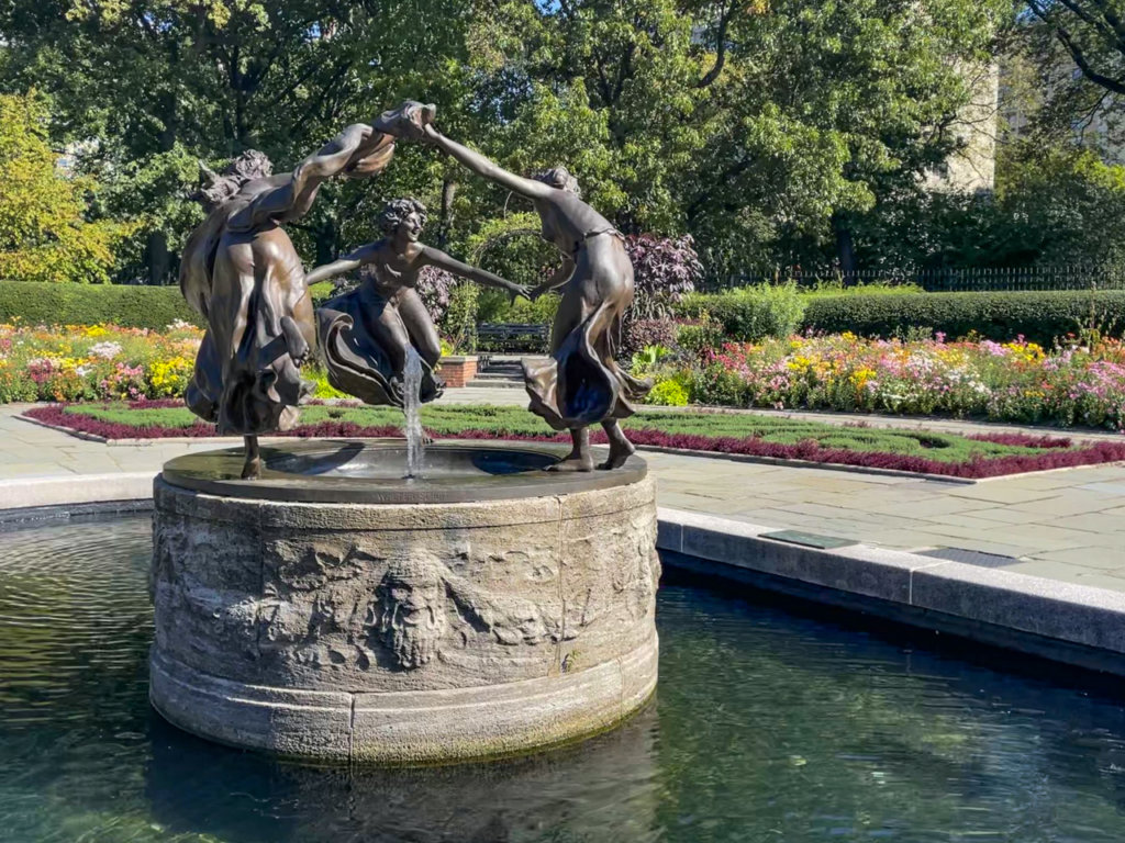 Bronze fountain and statue of three girls dancing. 