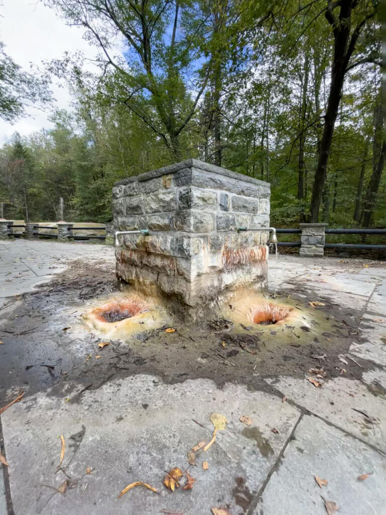Saratoga mineral spring flowing out of a square, brick shaped fountain. 