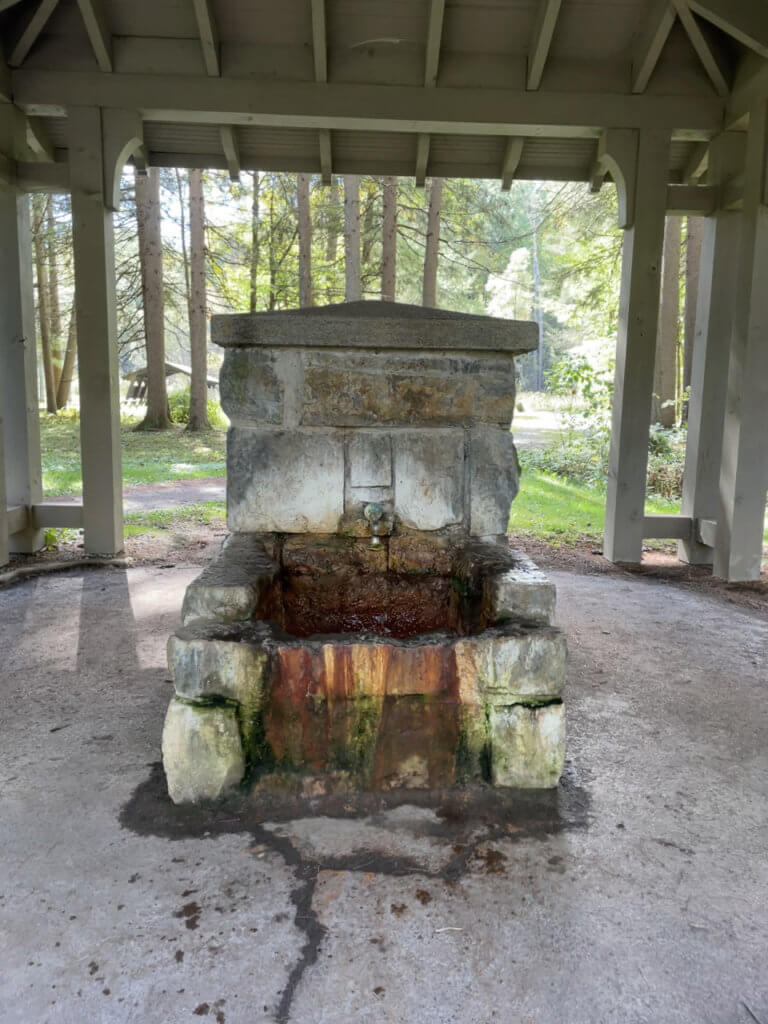 Water flowing naturally from a stone mineral water fountain. 
