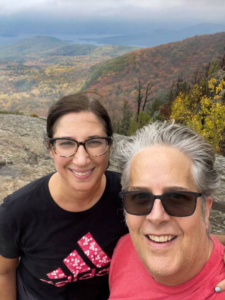 Man and woman smiling at Sleeping Beauty hiking trail summit.