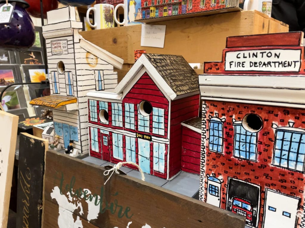Wooden birdhouses painted to resemble landmarks like the local fire station.