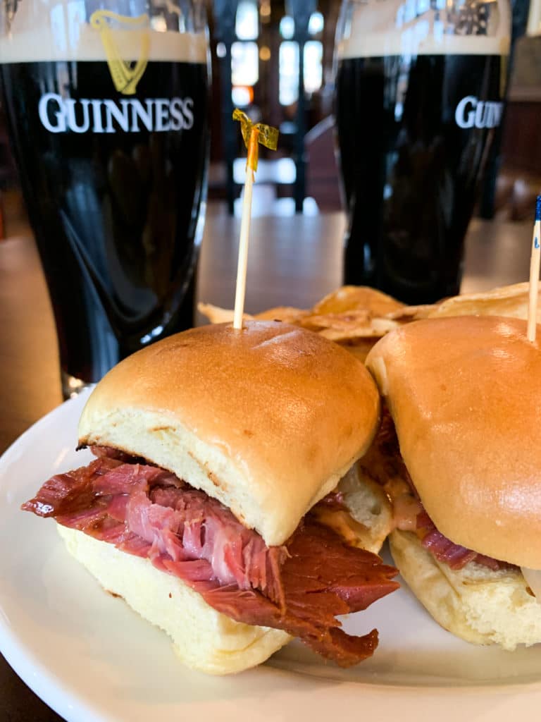 Two corned beef sliders and two pints of Guinness beer. 
