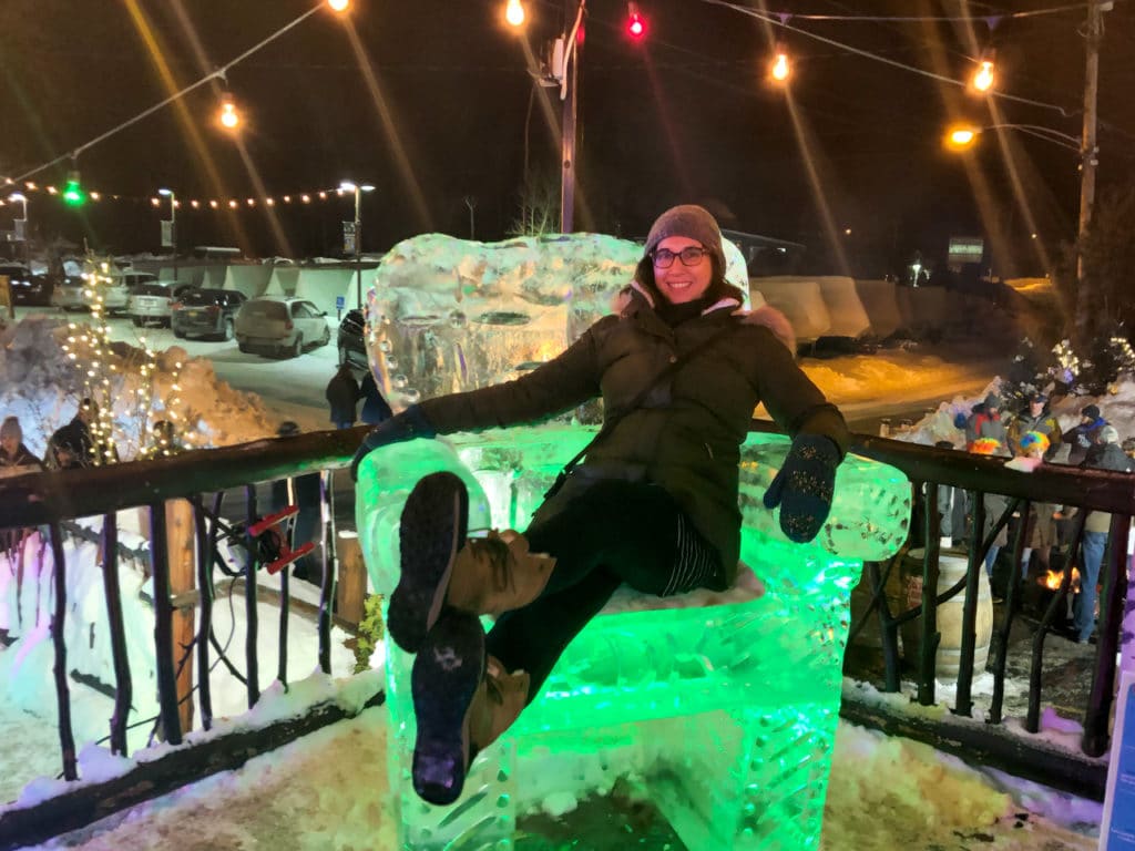 Woman sitting on a throne carved out of ice.