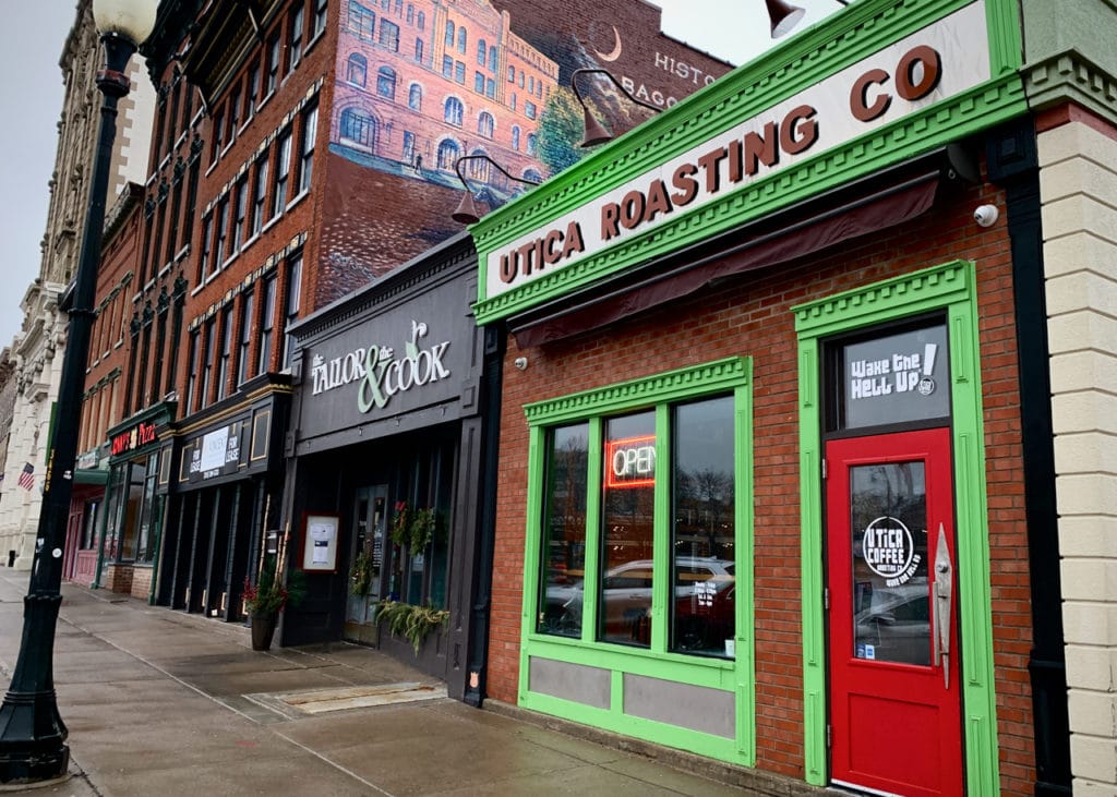 Row of restaurants including Utica Roasting Co., and The Tailor & The Cook.