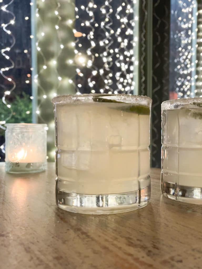 Two Margarita cocktails on a table in a restaurant. 