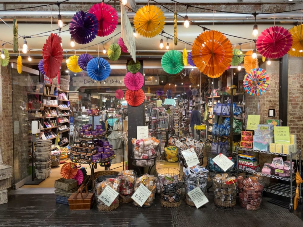 A storefront in Chelsea Market decorated with brightly colored round paper decorations. 