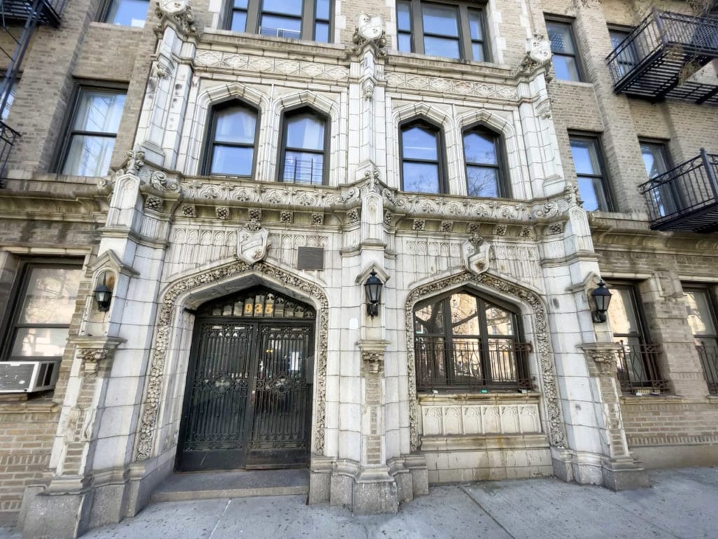 Entrance to an ornate stone apartment building in Harlem. 