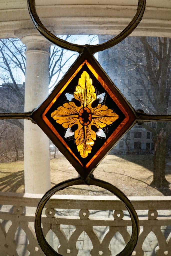 A decorative glass gold leaf embedded into a window. 