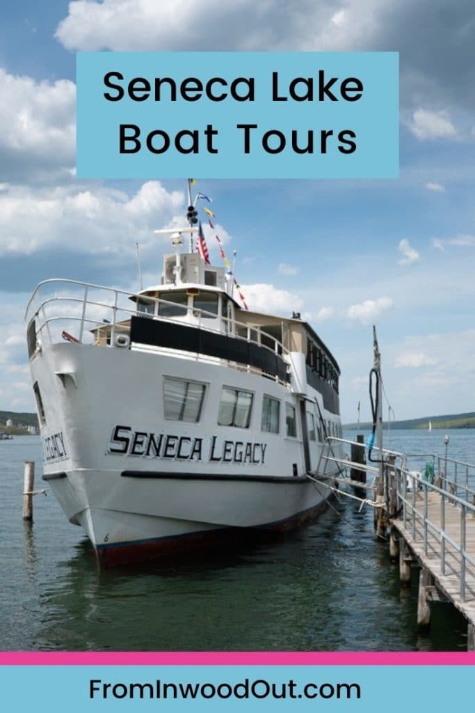 A boat named the Seneca Legacy tied to a dock in the lake.