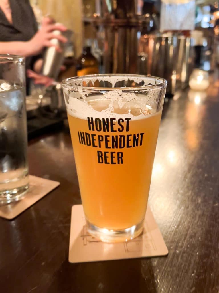 Draft beer in a glass that says Honest Independent Beer.