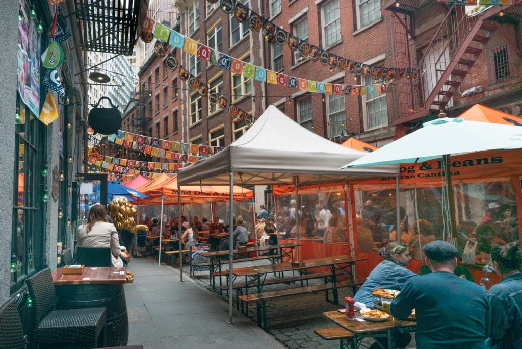 A city block of outdoor dining on Stone Street in New York City.