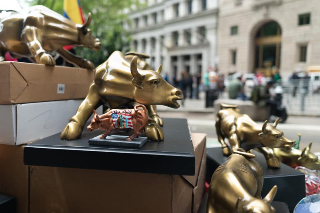 Souvenir replicas of the Charging Bull of Wall Street near the actual bull.