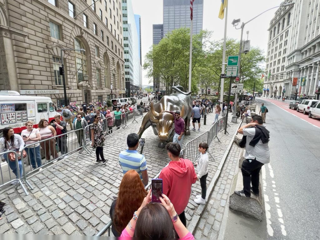 Charging Bull of Wall Street with a crowd of people around it.