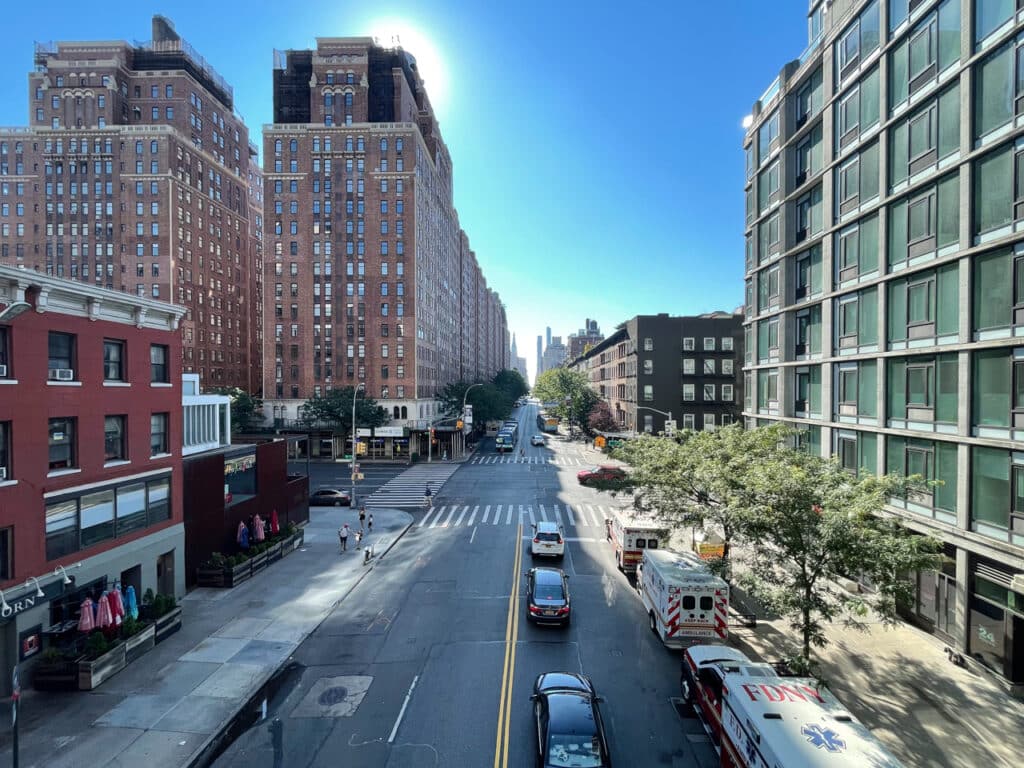 A view looking down the streets of New York City from the perspective of the elevated High Line.