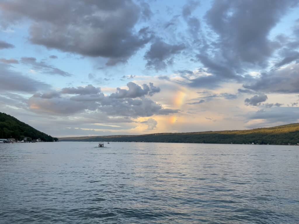 A rainbow in the clouds at sunset over Keuka Lake in Hammondsport, NY.