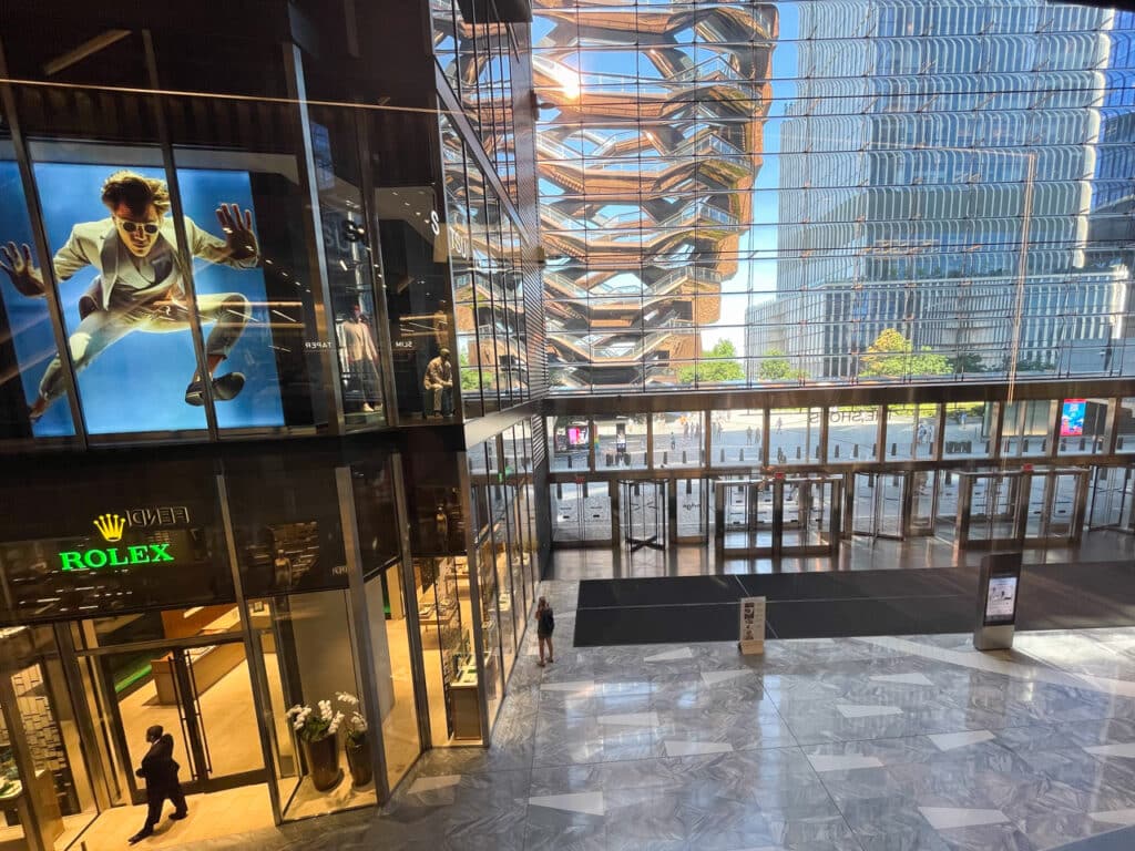 Inside the Shops at Hudson Yards, looking out onto the Vessel in New York City.
