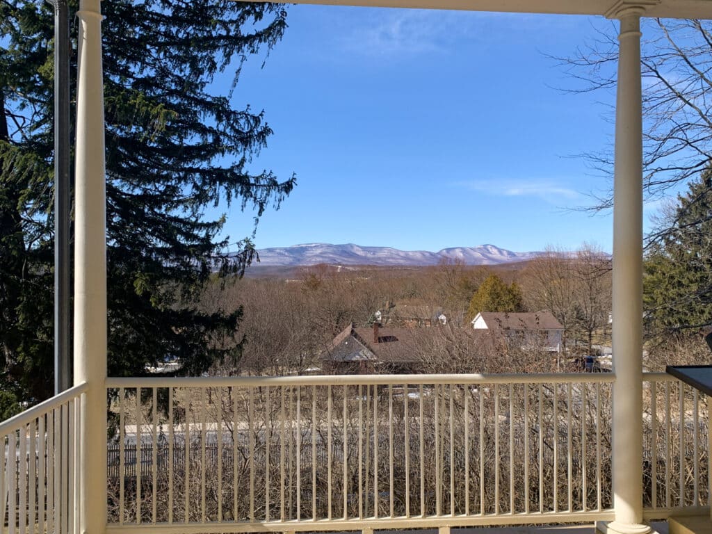 View of mountains in the distance seen from the porch of Thomas Cole National Historic Site in Catskill, NY. 