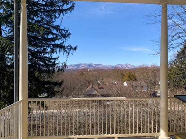 View of mountains in the distance seen from the porch of Thomas Cole National Historic Site in Catskill, NY.