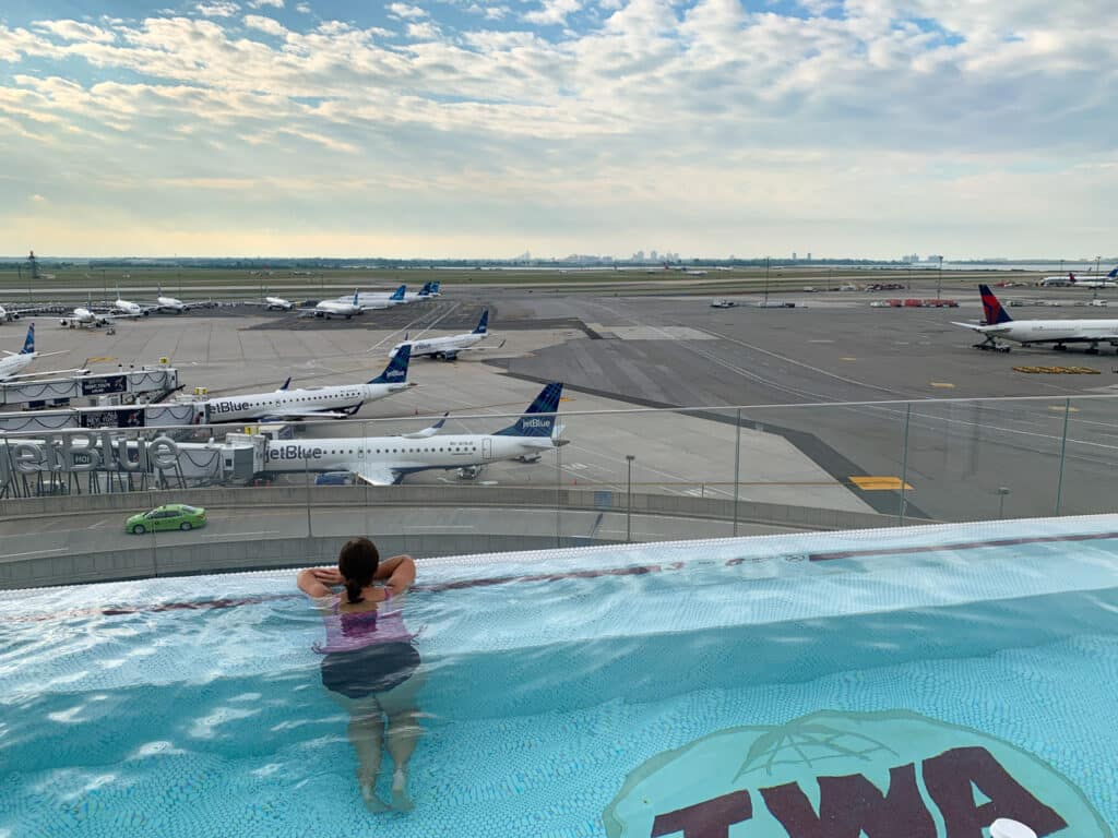 Woman in a rooftop swimming pool at TWA Hotel at JFK Airport in New York City. 